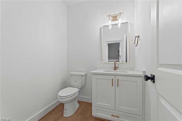 bathroom featuring hardwood / wood-style flooring, vanity, and toilet