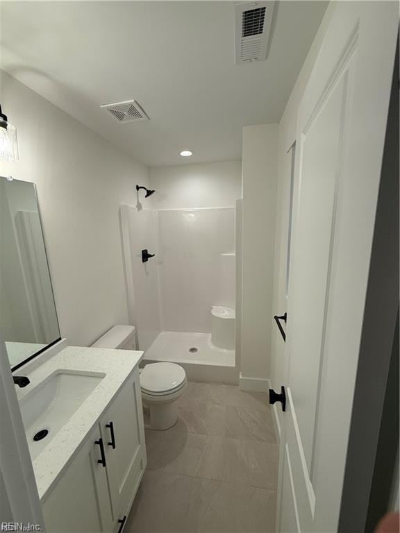 bathroom with walk in shower, vanity, and toilet