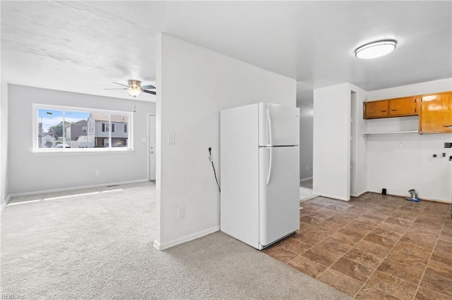 kitchen with dark colored carpet, white fridge, and ceiling fan