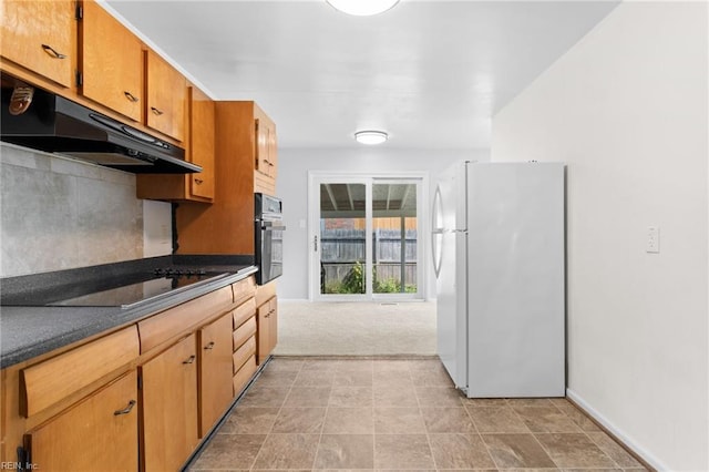 kitchen with black electric stovetop, light colored carpet, oven, and white refrigerator