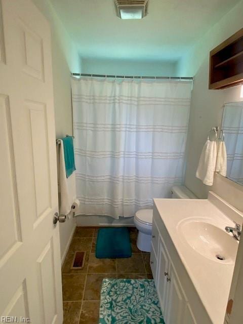 bathroom featuring vanity, tile patterned flooring, and toilet