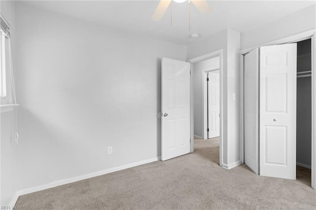 unfurnished bedroom featuring light colored carpet, a closet, and ceiling fan