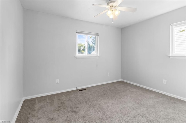 unfurnished room featuring carpet floors, a healthy amount of sunlight, and ceiling fan