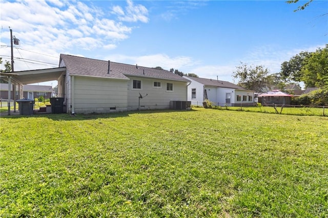 back of house with a yard and central air condition unit