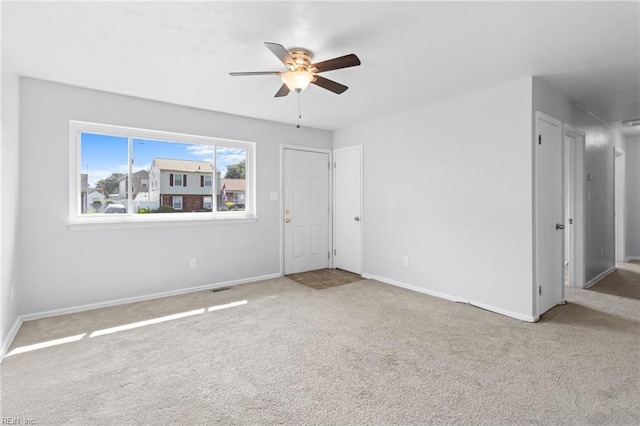 unfurnished room featuring ceiling fan and carpet flooring