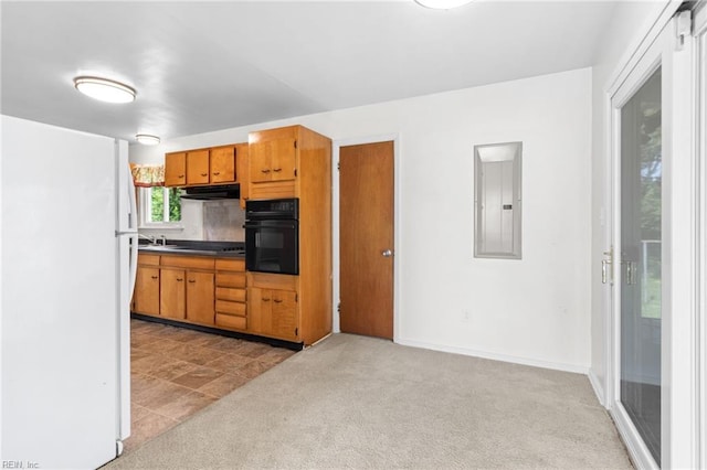 kitchen featuring sink, electric panel, white fridge, light colored carpet, and oven