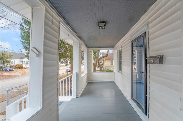 unfurnished sunroom featuring wood ceiling