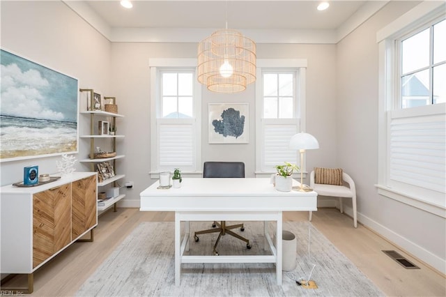 home office featuring plenty of natural light, a chandelier, and light wood-type flooring