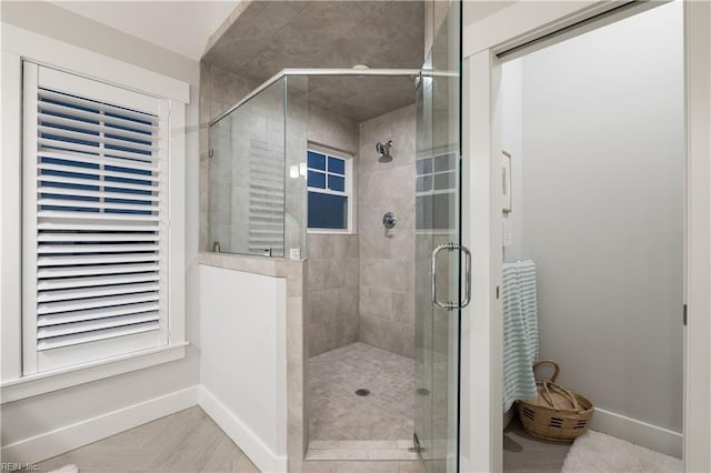 bathroom with a shower with door