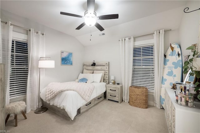 carpeted bedroom with vaulted ceiling and ceiling fan