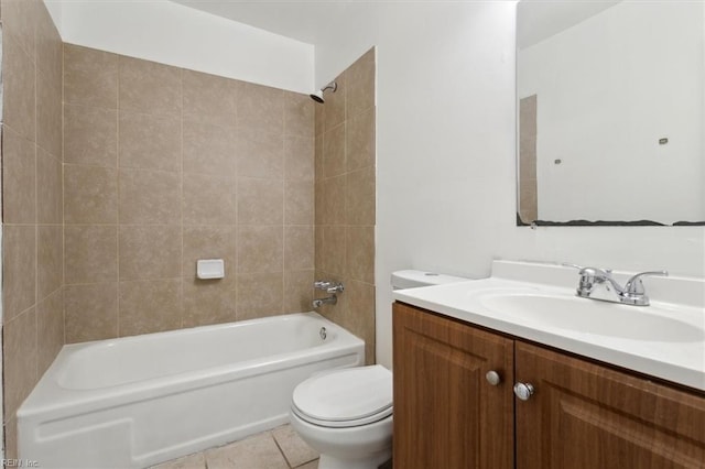 full bathroom with tile patterned flooring, vanity, tiled shower / bath, and toilet