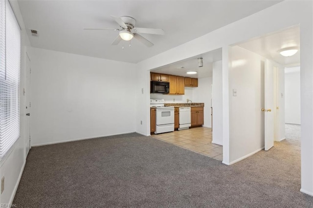 kitchen with ceiling fan, light colored carpet, and white appliances