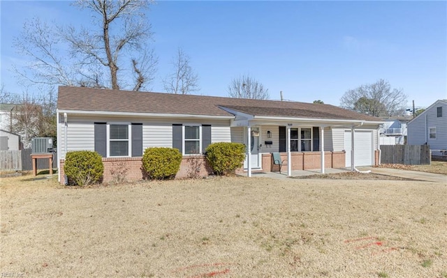 single story home with a garage, central AC unit, covered porch, and a front lawn