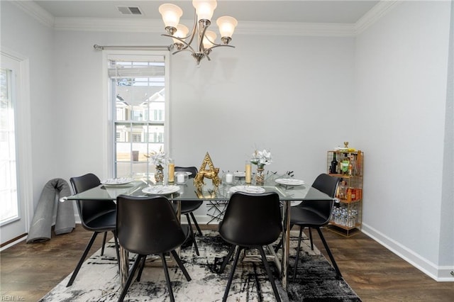 dining space featuring crown molding, dark hardwood / wood-style floors, and an inviting chandelier