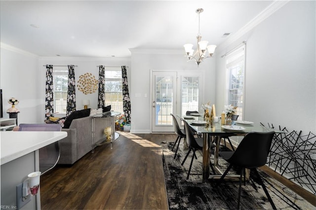 dining room featuring an inviting chandelier, plenty of natural light, ornamental molding, and dark hardwood / wood-style floors