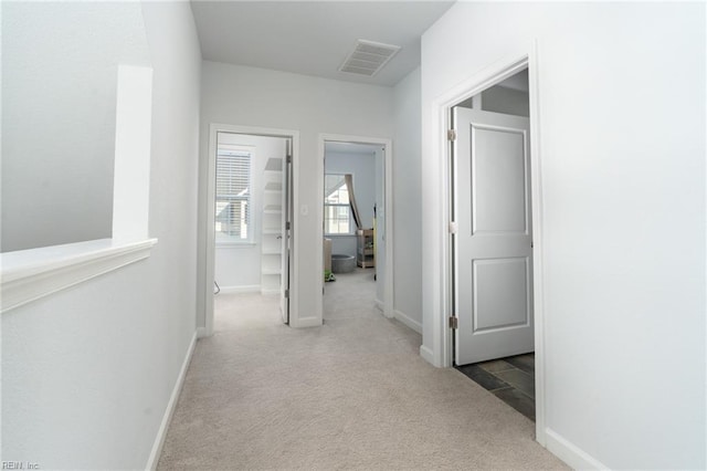 corridor with light colored carpet