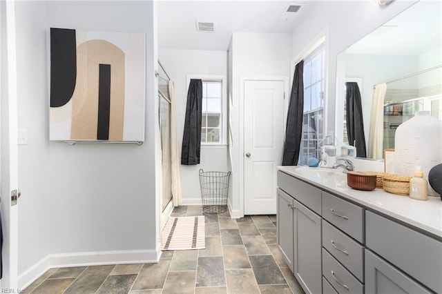 bathroom featuring vanity and a shower with shower door