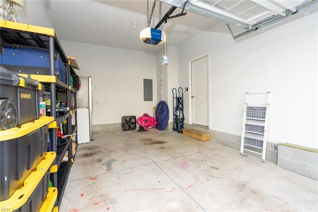 garage with stainless steel refrigerator, a garage door opener, and electric panel