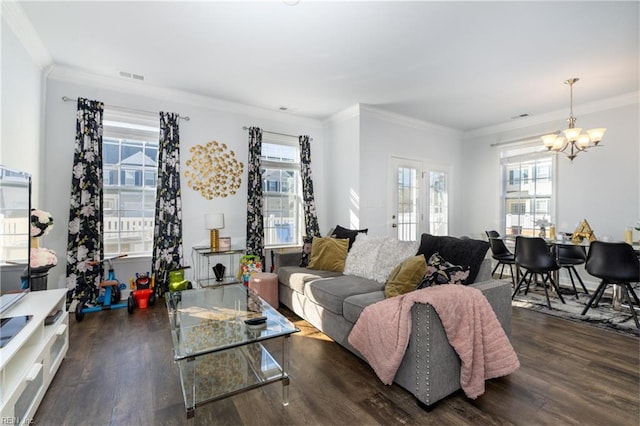 living room with crown molding, a chandelier, and dark hardwood / wood-style flooring