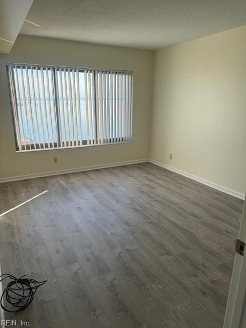 empty room with dark wood-type flooring