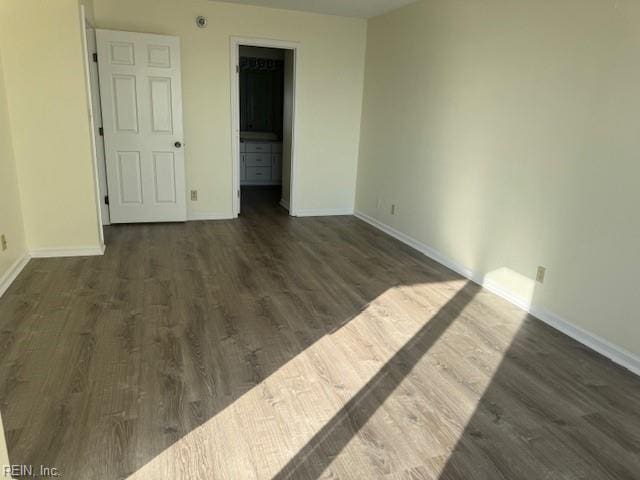 unfurnished room with dark hardwood / wood-style floors