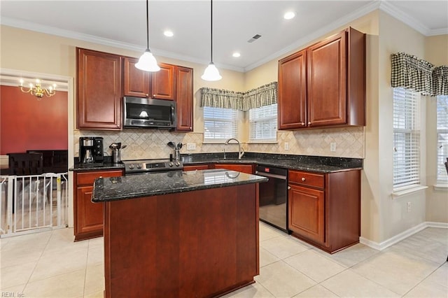 kitchen featuring a kitchen island, decorative light fixtures, dark stone countertops, stainless steel appliances, and crown molding