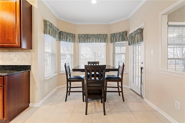 dining room with light tile patterned floors and ornamental molding