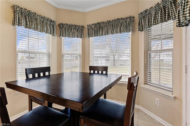 dining room with crown molding and light tile patterned flooring