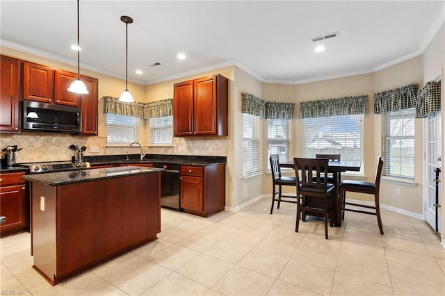 kitchen featuring sink, dishwasher, hanging light fixtures, a center island, and dark stone counters