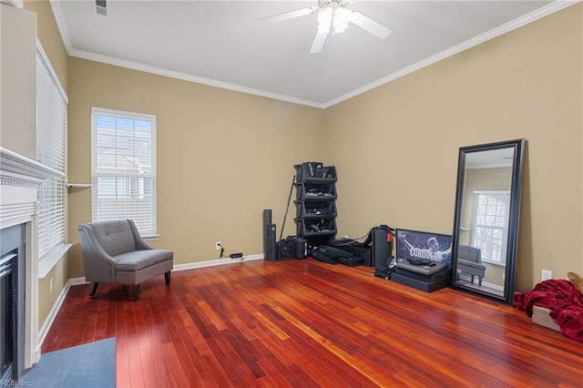 sitting room with hardwood / wood-style flooring, ornamental molding, and ceiling fan