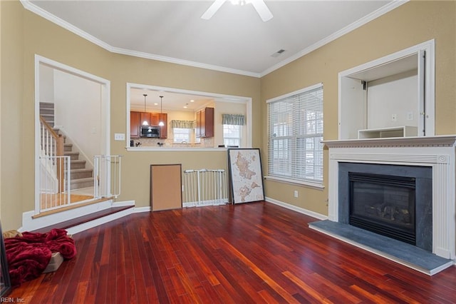 unfurnished living room with crown molding, dark hardwood / wood-style floors, and ceiling fan