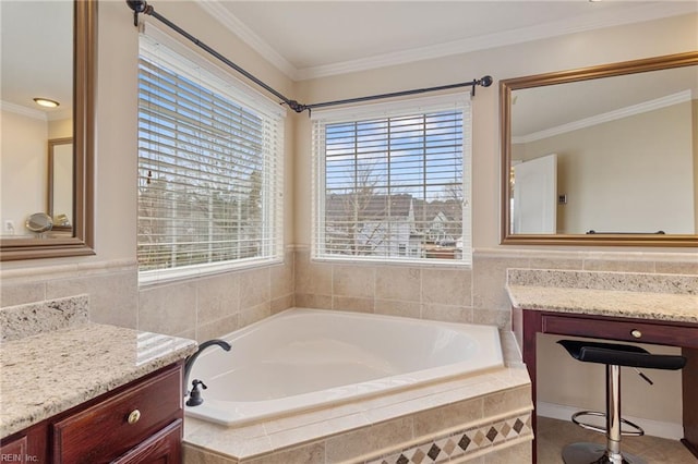 bathroom featuring vanity, ornamental molding, and a relaxing tiled tub