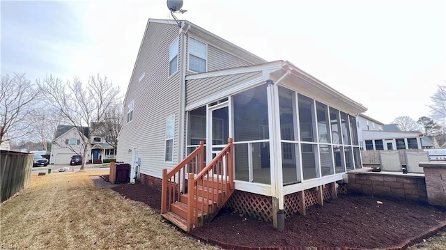 view of side of home with a sunroom