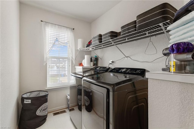 clothes washing area with washer and dryer