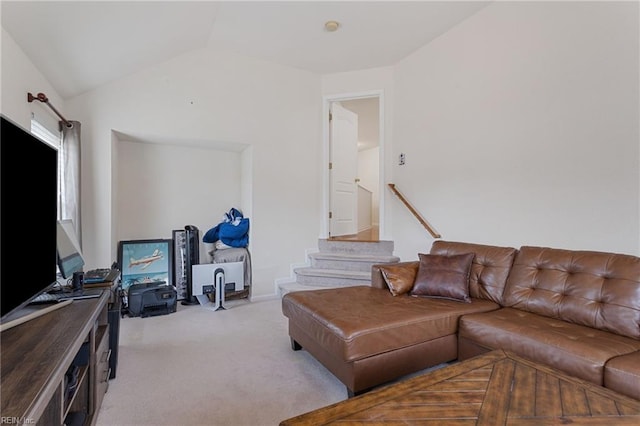 carpeted living room with vaulted ceiling