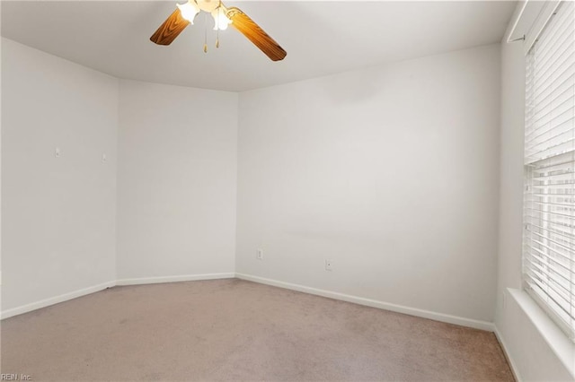 carpeted spare room featuring ceiling fan