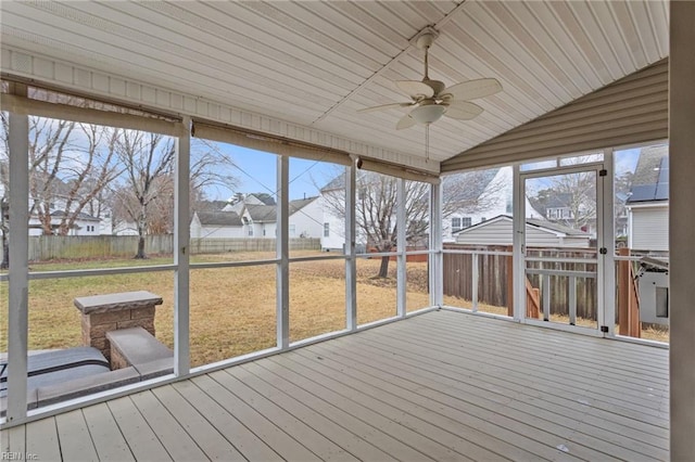 unfurnished sunroom featuring plenty of natural light, lofted ceiling, and ceiling fan