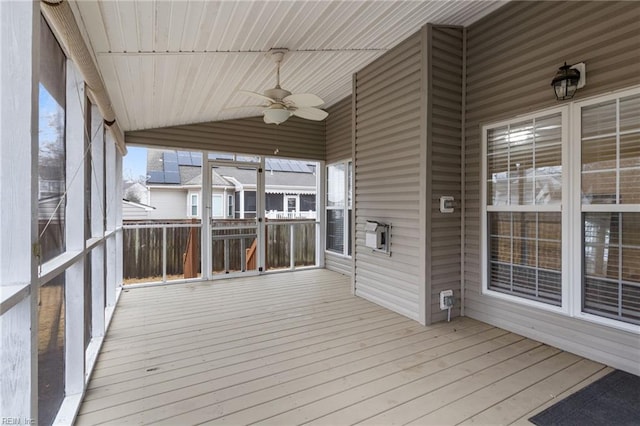 unfurnished sunroom with ceiling fan, lofted ceiling, and wooden ceiling