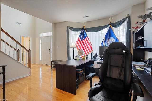 home office with light hardwood / wood-style floors