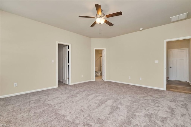 carpeted spare room featuring ceiling fan