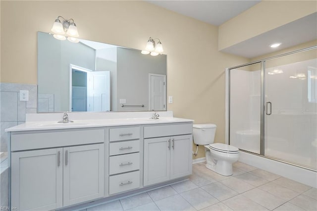 bathroom featuring vanity, toilet, tile patterned floors, and a shower with shower door