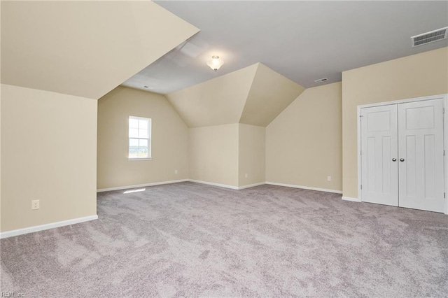 bonus room featuring light carpet and vaulted ceiling