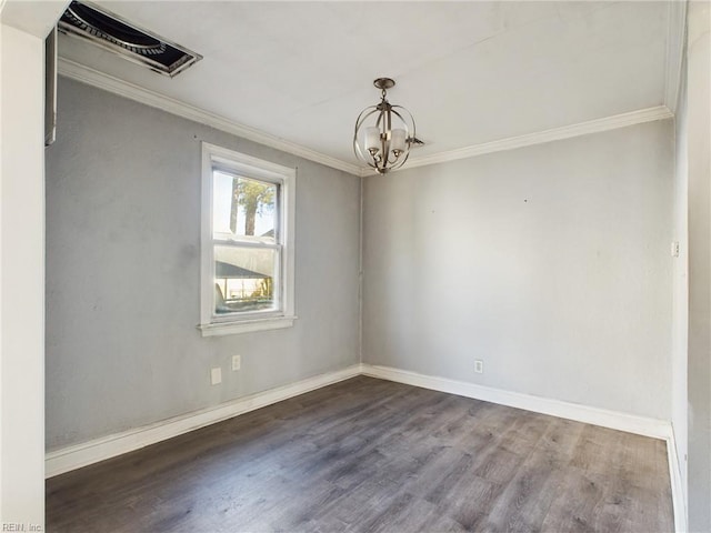 empty room with ornamental molding, dark hardwood / wood-style floors, and a chandelier