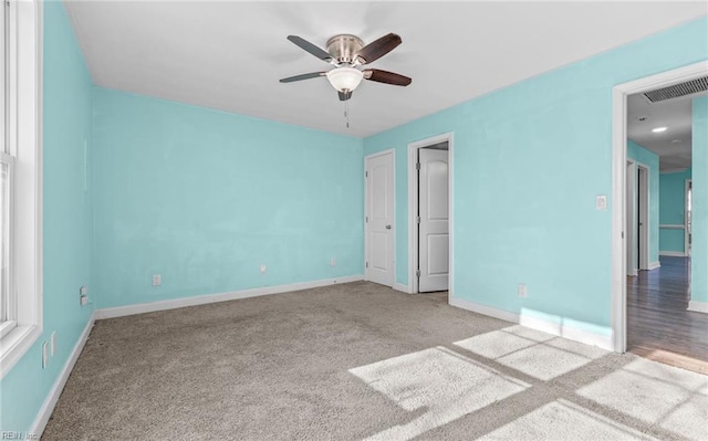 unfurnished bedroom featuring light colored carpet and ceiling fan