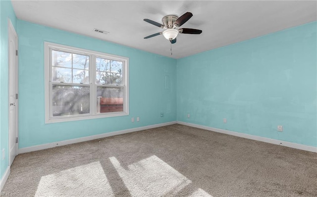 spare room with carpet floors and ceiling fan