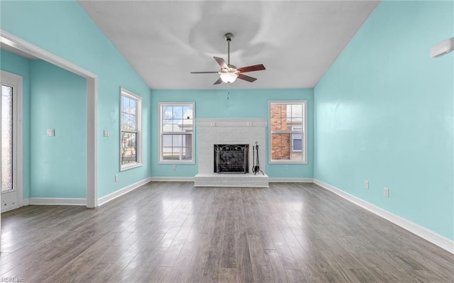 unfurnished living room featuring a brick fireplace, hardwood / wood-style floors, lofted ceiling, and ceiling fan