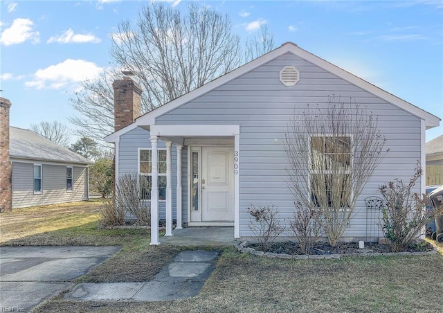 bungalow-style house featuring a front yard