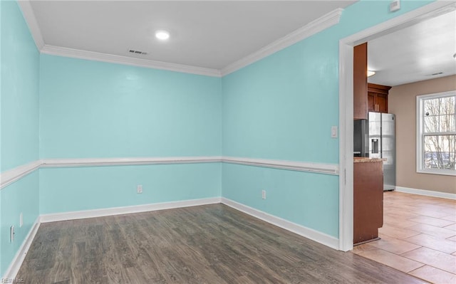 empty room with crown molding and dark hardwood / wood-style floors