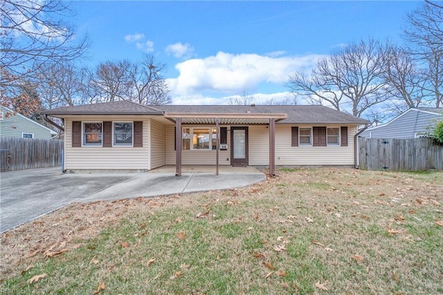 view of front of house with a front yard and a patio area