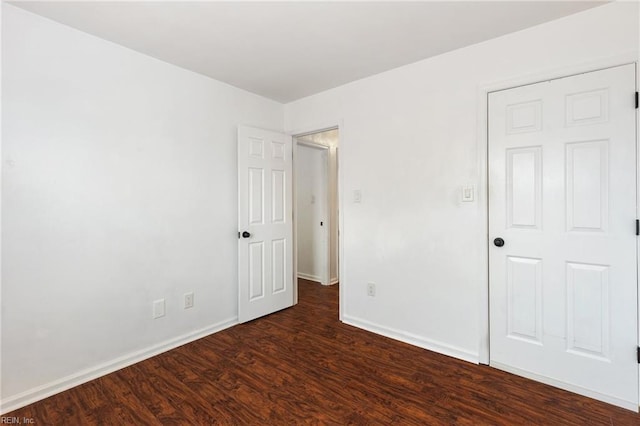 spare room featuring dark hardwood / wood-style flooring